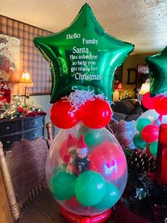 some balloons are sitting in a vase on a table with other christmas decorations and gifts