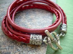 A Metallic Red Leather Bracelet.... Super stylish and feminine, wrap this twice around your wrist, toggle up and off you go. This Double Wrap Leather Bracelet features 3mm round, 3mm braided and 5mm flat braided metallic leather cords. Lead and Nickel Free - Aged Silver Toned Alloy Components, Secure Toggle Closure for Easy on and off. All dyes used in our leather are certified 100% Lead-Free and meet all requirements of the German Goods Ordinance, REACH (European Union), RoSH (U.K.), and CPSIA Handmade Red Wrap Bracelet, Adjustable Burgundy Bracelets, Trendy Red Adjustable Leather Bracelet, Red Leather Bracelet, Leather Bracelets Women, Bracelet Leather, Womens Jewelry, Toggle Bracelet, Leather Bracelets