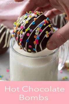 chocolate covered donuts with sprinkles in a glass full of milk for dipping