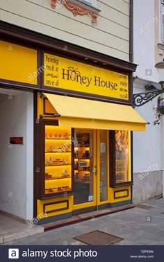 a store front with yellow awnings on the side of it's windows