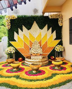 an elaborate flower display in the middle of a walkway with potted plants on it