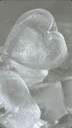 some ice cubes are sitting on top of each other in a bowl with water