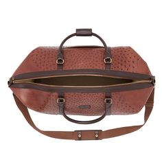 Built with Lucchese’s own Full Quill Ostrich leather, this signature duffle totes your essentials in first class style. The fold-end construction allows for maximum packing space, which includes natural, water-resistant canvas lining, an interior zipper pocket and two open storage slots. Luxury Weekender Bag With Leather Backing, Travel Bag In Textured Leather And Coated Canvas, Designer Leather Travel Bag With Leather Handles, Luxury Coated Canvas Bags For Overnight Trips, Luxury Textured Leather Duffle Bag For Daily Use, Luxury Textured Leather Travel Bag For Everyday, Luxury Textured Leather Travel Bag, Luxury Leather-backed Tote Weekender Bag, Top Handle Leather Duffle Bag With Leather Trim