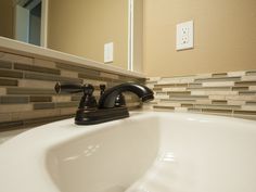 a bathroom sink with faucet and soap dispenser next to it