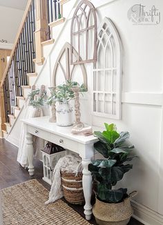 some plants are sitting on a bench in front of the stairs and window sill