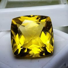 a yellow diamond sitting on top of a white box