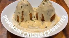 two pieces of chicken covered in gravy on a plate with the words homemade chicken croutets