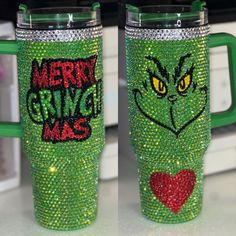 two green mugs with merry gringie mac designs on them, one has a red heart and the other has a green handle