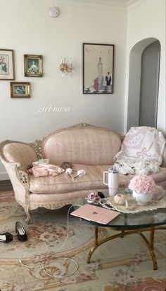 a living room filled with furniture and pictures on the wall above it's coffee table