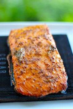 a piece of cooked salmon sitting on top of a black mat