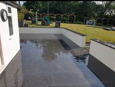 an outdoor area with black and white tiles on the ground