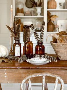 a wooden table topped with bottles filled with different types of food and decorating items