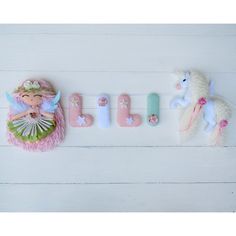 the name lilly spelled out with toy animals and other items on a white wooden surface