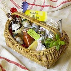 a wicker basket filled with food and condiments on top of a bed