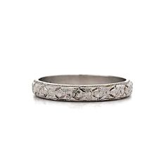 Vintage Art Deco Engraved Orange Blossom Band in Platinum This Art Deco wedding band showcases the elegance and meticulous craftsmanship of the early 20th century. Crafted from polished platinum, the band features an intricate Orange Blossom engraved pattern that wraps around the entire circumference. The detailed engraving highlights the exceptional artistry of the era. Milgrain edges add a refined touch, enhancing the overall design. Perfect as a wedding band or a standalone piece, this ring combines historical charm with timeless beauty, making it a cherished addition to any jewelry collection. CHARACTERISTICS Ring Size: 6.0 Resizable: Yes Height Above Finger: 1.35 mm Measurements: 3.10 mm Era: Art Deco/Antique Composition: Platinum Total Gram Weight: 3.2 g Inscription: PLATINUM -- ALL Classic White Gold Engraved Ceremonial Ring, Classic White Gold Ceremonial Engraved Ring, Classic White Gold Engraved Ring For Ceremonial Occasions, Classic Ceremonial White Gold Engraved Ring, Classic Silver Bands With Single Cut Diamonds, Classic Ceremonial Engraved Ring With Etched Details, Classic Ceremonial Diamond Cut Rings, Classic Etched Rings For Anniversary, Classic Silver Bands With Diamond Cut