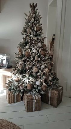 a decorated christmas tree with presents under it