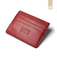 a red leather business card holder with the initials m & s on it and an embossed logo