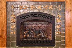 the fireplace is decorated with leaves and flowers