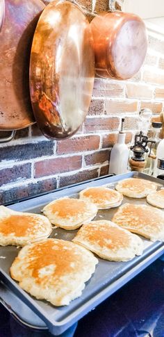 pancakes are being prepared on a baking sheet