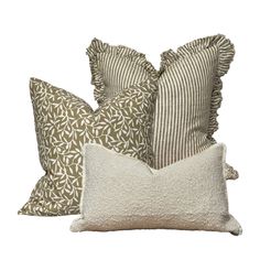 three pillows with ruffled edges and one pillow on the side, both in beige