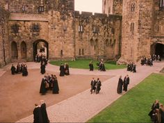 a group of people standing in front of a castle