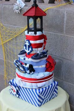 a cake made to look like a lighthouse with red, white and blue decorations on it