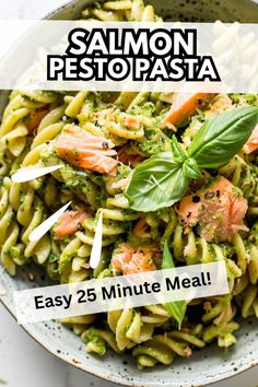 salmon pesto pasta in a white bowl with basil leaves on top and the words easy 25 minute meal