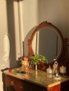 a vanity with a mirror and candles on it