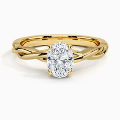 a yellow gold engagement ring with a oval cut diamond in the center and twisted band