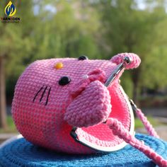 a pink stuffed animal sitting on top of a blue blanket