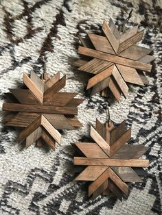 three wooden snowflakes sitting on top of a rug