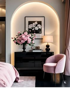 a bedroom with pink furniture and flowers in the vase on the dresser next to the bed