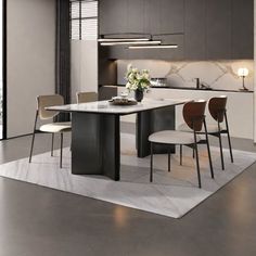 a modern kitchen with an island table and chairs