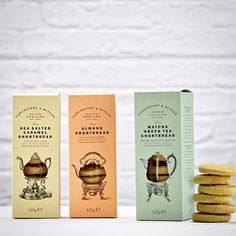 three different flavors of cookies next to each other on a table with white brick wall in the background