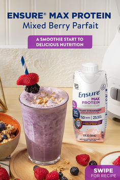 a smoothie with berries and granola on the side