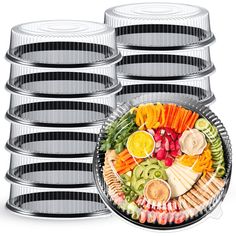 a platter filled with lots of different types of food next to stacks of cake tins