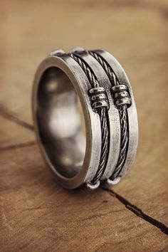 A twisted wire creates a unique pattern on a band ring. A simple band is not simple anymore! Made of solid sterling silver 925 with a touch of oxidization for an amazing look. Make it even more special by having the ring engraved. PRODUCT DETAILS The ring is 9.3mm wide (approx. 0.36in) and 2.85mm thick (approx. 0.11in). The ring is oxidized to bring out its unique look. OPTIONS --> The ring is available in many different sizes. You may choose the one you wish from the drop-down menu. If you p Male Jewelry, Simple Band, Pattern Ring, Silver Spinner Rings, Twisted Wire, Mens Silver Rings, Ring For Men, Men's Jewelry Rings, Unisex Ring