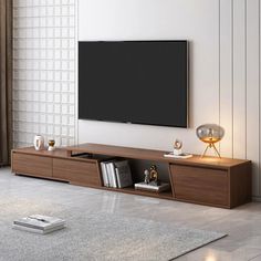 a flat screen tv sitting on top of a wooden entertainment center in a living room