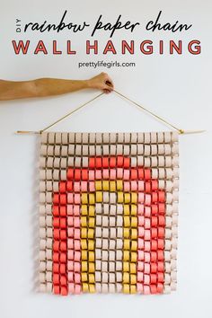 a wall hanging made out of lego blocks with text overlay reading 5 rainbow paper chain wall hanging