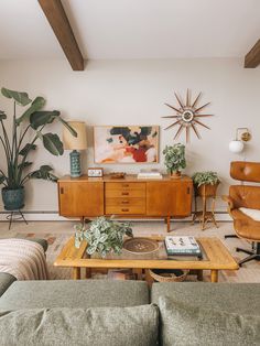 a living room filled with furniture and plants