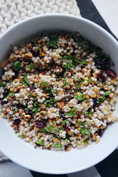 a white bowl filled with food on top of a table