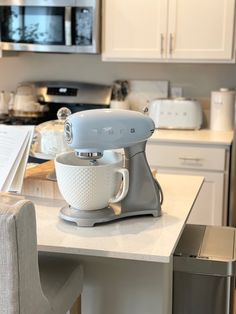 a white mixer sitting on top of a kitchen counter