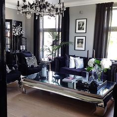 a living room filled with furniture and a large mirror on top of the coffee table