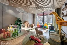 the children's playroom is decorated with colorful furniture and toys, as well as a giraffe statue