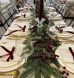 the table is set for christmas dinner with red and green decorations