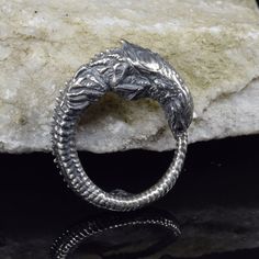 Enter the surreal world of H.R. Giger with our handcrafted silver Alien Newborn Ring Chestburster--a collector's item with a unique design inspired by the iconic extraterrestrial creature. Crafted in sterling silver, this statement ring captures the essence of sci-fi and pop culture, making it an unconventional and stylish accessory for collectors and enthusiasts. Alien Ring, Sci Fi Jewelry, Surreal World, Index Finger Rings, Unique Jewelry Designs, Jewelry Unique, Stylish Accessories, Statement Ring, Science Fiction