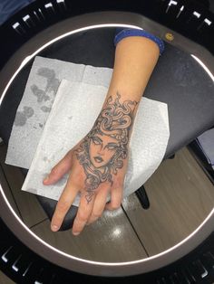 a woman's hand with a tattoo on it