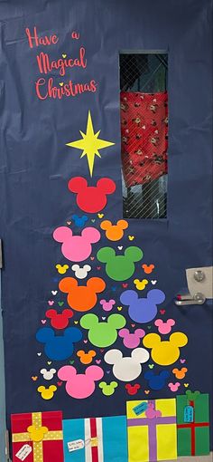 a door decorated to look like a christmas tree with mickey mouse heads on it and the words have a magical christmas