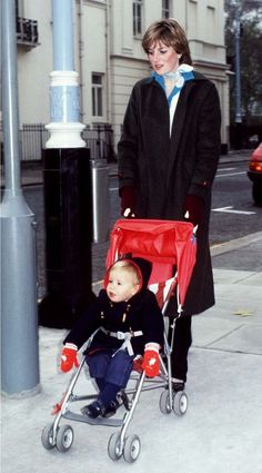 a woman pushing a stroller with a small child in it