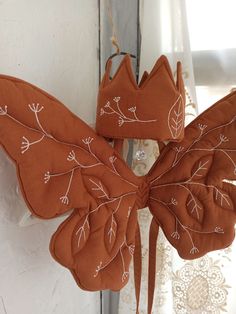 an orange butterfly decoration hanging from a window